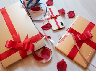 tech gifts wrapped with red gift bows