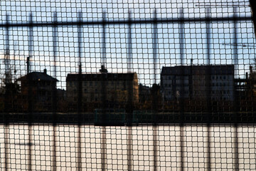 A fence with buildings in the background