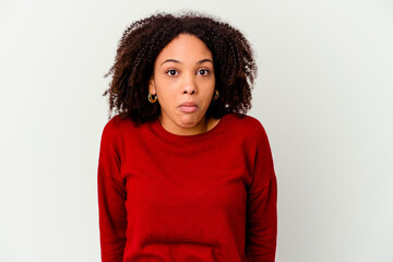 Young african american mixed race woman isolated shrugs shoulders and open eyes confused.