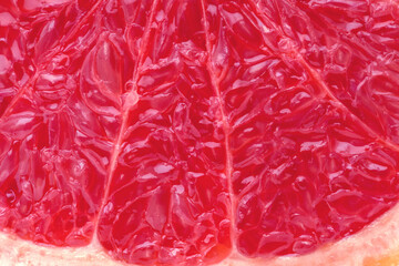 Juicy ripe red grapefruit piece cut closeup