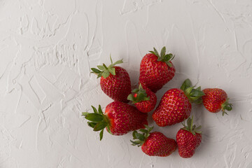 Group of Red, Ripe Strawberries Fresh From the Garden on White Textured Background
