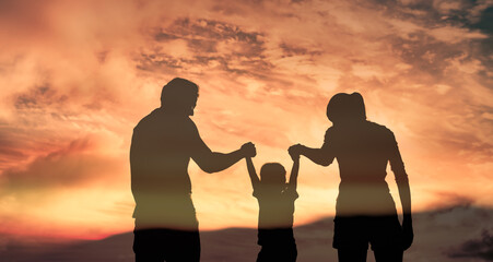 Happy family silhouette playing holding hands