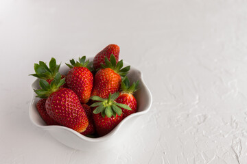 Bowl of Red, Ripe Strawberries Fresh From the Garden on White Textured Background