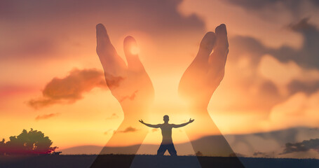 Man looking up to the sky feeling rejuvenated. Hands worshiping reaching out to sky, warm sunshine in the palm of hands.	