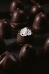 Chocolate souffle sweets or bird's milk on a dark background