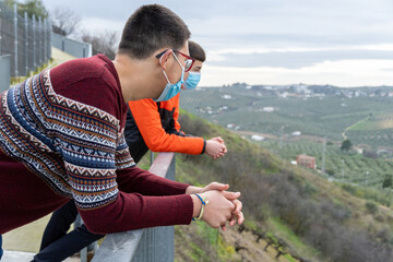 Stock photo of teenagers standing in viewpoint and enjoying the views.