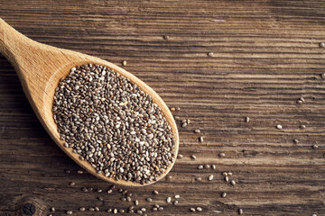 Chia seeds on a wooden cooking spoon with copy space