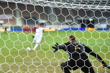 Net in the football goal penalty shootout in the background. - obrazy, fototapety, plakaty