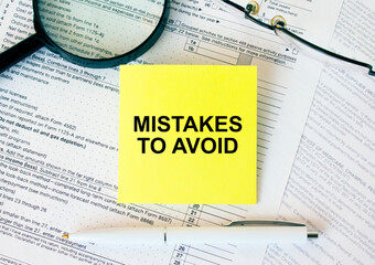 Yellow sticker with text Mistakes To Avoid on financial docs