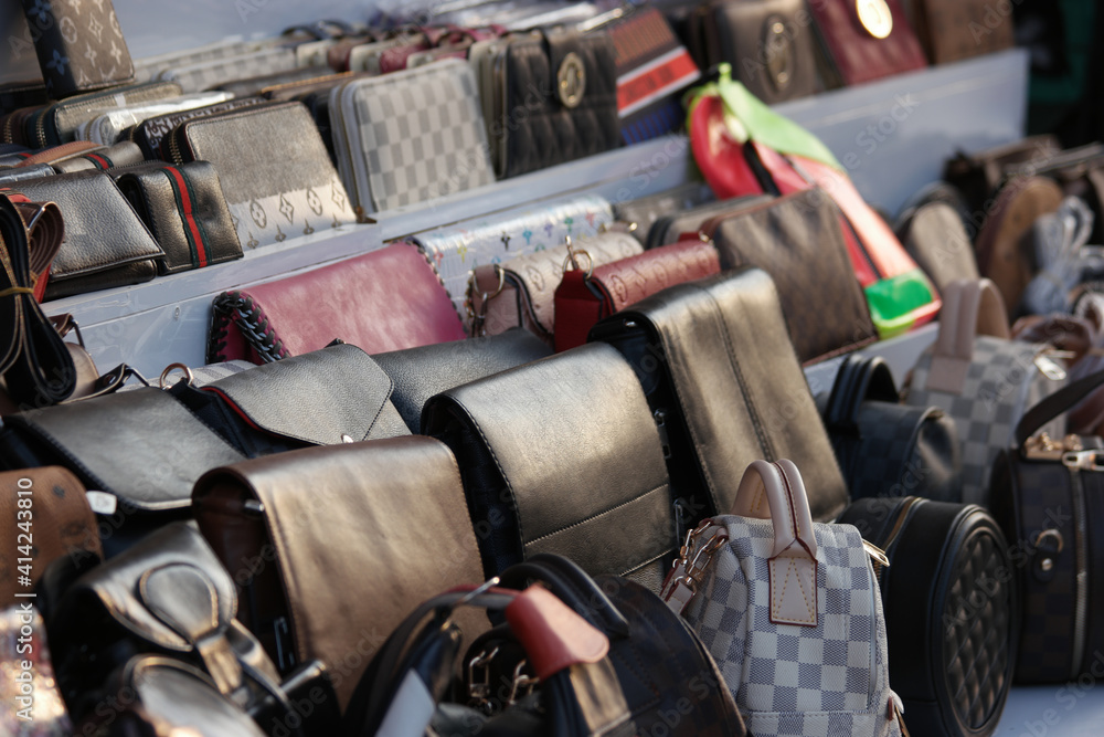 Wall mural set of various leather bags close up. display with assorted bags at market store. male and female ac