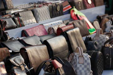Set of various leather bags close up. Display with assorted bags at market store. Male and female...