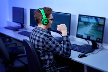 A professional gamer plays and wins a first-person game online on his personal computer.