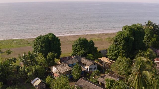 Village of Jovi on the Colombian Pacific shore, drone arial view with ethnic settlement huts, rainforest by Pacific Ocean, Choco