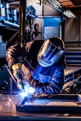 A welder welding in factory