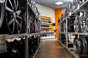 Fototapeta premium rack of car wheels in shop, no people, copy space. auto, car, transport, repairing concept