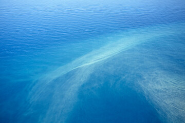 Beautiful sea water surface from above. Clear blue sea in calm water seascape.