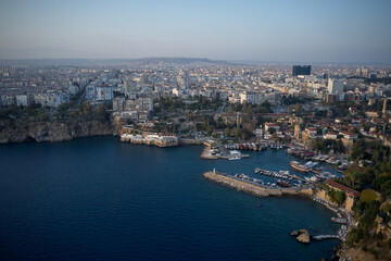 Obraz premium Beautiful Mediterranean seascape in Turkey. Panoramic view of sea coast with buildings on shore. Boats and yachts anchored at harbor in sea bay.