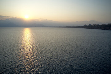Aerial drone view of sunrise or sunset scene over the sea. Beautiful seascape view in the morning.