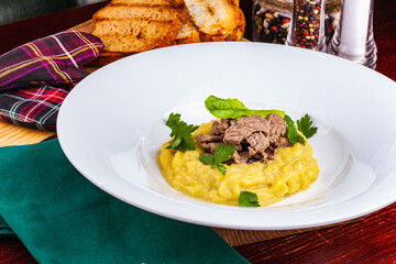 Beef Stroganoff with mashed potatoes on white plate