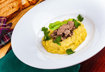 Beef Stroganoff with mashed potatoes on white plate