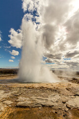 Famous Haukadalur geyser erupting on a sunny day
