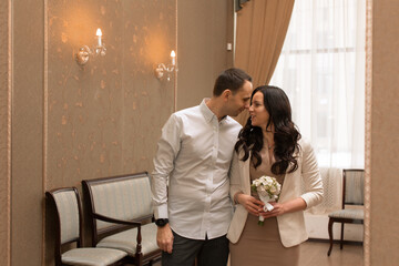 Beautiful and happy newlyweds marry each other and get married. New family and marriage. Registration at the registry office