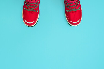 Kids or teenage pink winter boots isolated on blue background. Winter boots for girls. Top view banner