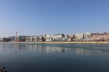 Fototapeta premium Immeubles sur le quai Perrache à Lyon le long du fleuve Rhône en hiver, ville de Lyon, département du Rhône, France