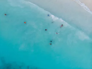 Foto op Canvas Aerial Drone Shot of Black local African Kids swimming in Turquoise Water of Indian Ocean at Zanzibar island, Nungwi © Oleksandr