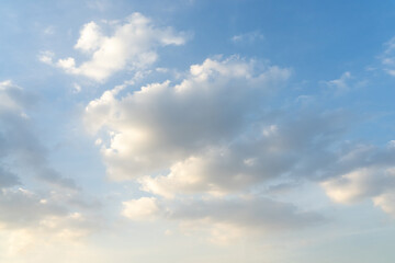 Blue sky with soft clouds background.