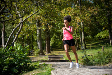 young metis woman running in a park