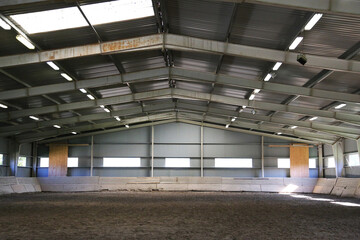 Photo of an empty indoor riding hall for horses and riders