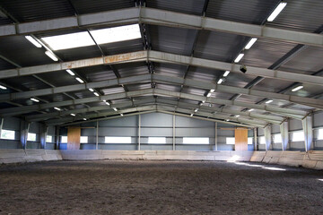 Photo of an empty indoor riding hall for horses and riders