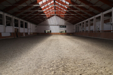 Photo of an empty indoor riding hall for horses and riders