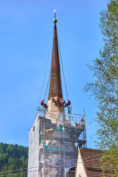 Roof repair on the church tower in Mareit, South Tyrol, Italy.