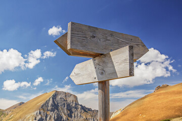 Wooden board sign for different directions on a mountain
