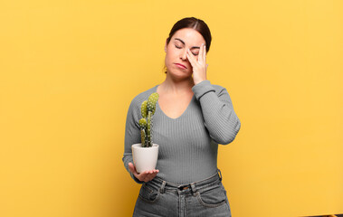 young pretty woman feeling bored, frustrated and sleepy after a tiresome, dull and tedious task,...