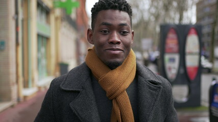 Naklejka premium Young handsome black African man portrait looking at camera wearing winter clothing