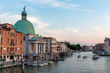 Venice's canal, boat and traditional Venetian houses view.	