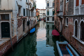 Venice's canal, boat and traditional Venetian houses view.	