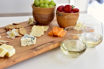 Gourmet wine and cheese charcuterie platter ordering out from restaurant for romantic date night at home on special occasion holiday or birthday. Photo concept, food lifestyle, background, close-up