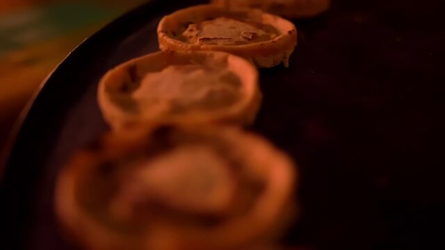 Row of small sopes on a black surface