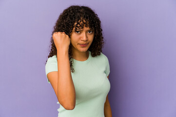 Young african american afro woman isolated showing fist to camera, aggressive facial expression.