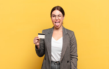 young pretty woman with cheerful, carefree, rebellious attitude, joking and sticking tongue out,...