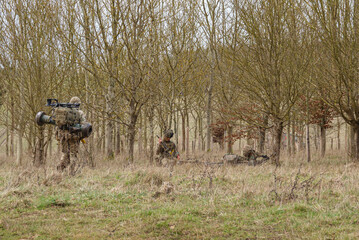 three british army soldiers at the end of an 8 mile tabbing exercise with fully loaded 25Kg bergens 