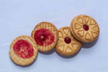 Red centered jam biscuits with a strawberry flavor and on a plain white background