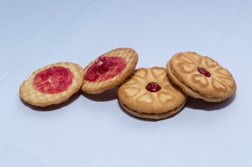 Red centered jam biscuits with a strawberry flavor and on a plain white background