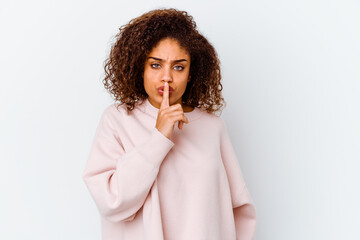 Young african american woman isolated on white background keeping a secret or asking for silence.