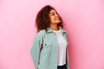 Young african american woman isolated on pink background relaxed and happy laughing, neck stretched showing teeth.