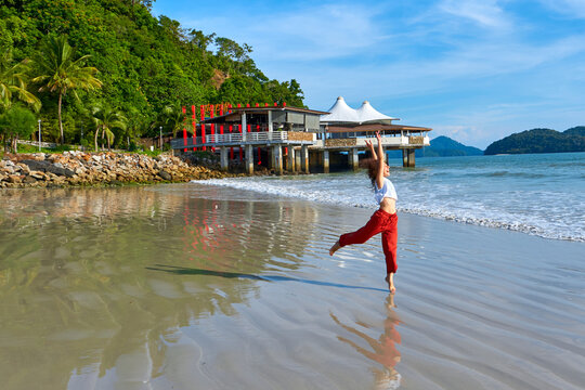 happy tourist woman enjoy travel on the central beach in Langkawi tropical island